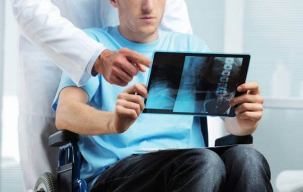 En mann med multippel sklerose ser på et røntgenbilde