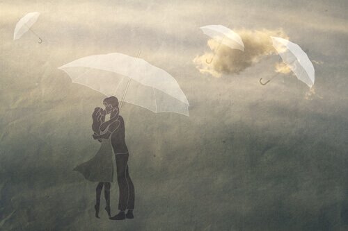 Par som står under en paraply