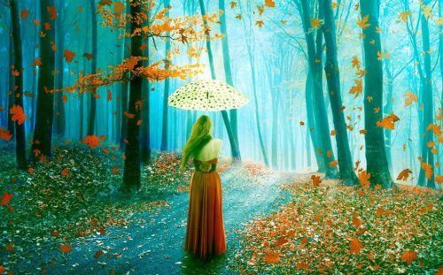 Jente med paraply i høstskog