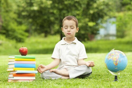 En gutt som sitter i en park og mediterer
