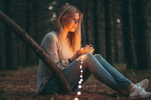 Kvinne med lys i skogen