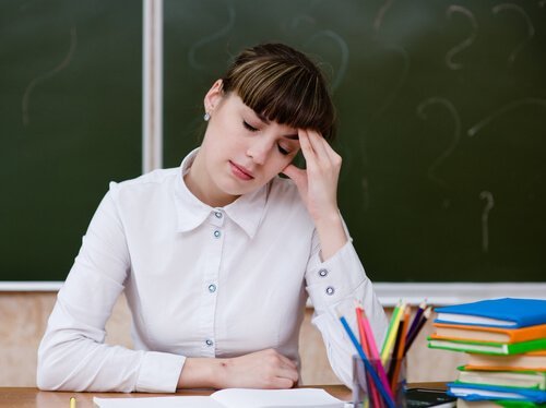 Stressa kvinnelig lærer ved kateteret
