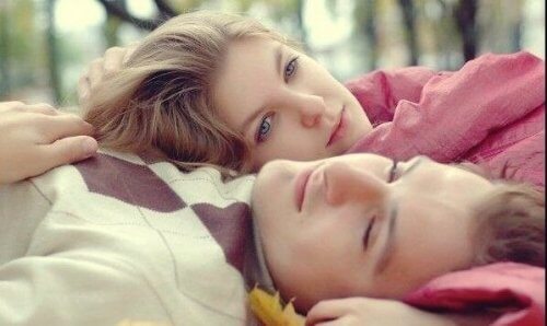 Et ungt par som ligger side ved side med halvåpne øyne