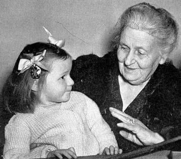 Maria Montessori snakker med en liten jente.
