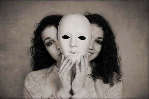 Et svart-hvitt bilde av ansiktet til to tilsynelatende identiske kvinner som gjemmer seg bak en maske.