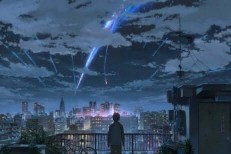 En ung person som ser over en by som ser ut til å ha meteorer som faller fra himmelen.